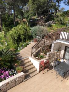 a patio with stairs and flowers in a garden at Babo Apartments in Hvar