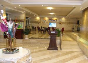 a lobby of a hotel with a table and chairs at The Saj Hotel in Ajman 