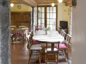a dining room with a table and chairs at Warmhill Farmhouse in Hennock