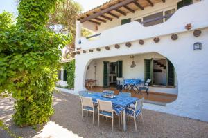 an outdoor patio with a blue table and chairs at Voramar Ham in Playa de Muro