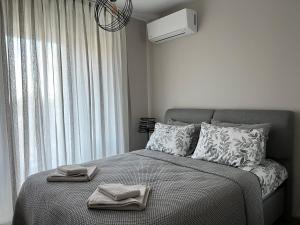 a bedroom with a bed with two towels on it at Luxe Sea in St. St. Constantine and Helena