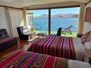 a bedroom with a bed and a view of the water at Uros Aruma-Uro on Uros Floating Islands in Puno