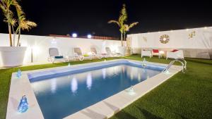 a swimming pool in a yard at night at Villa Amatista Salinas Golf & Beach in Caleta De Fuste