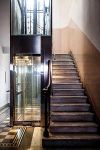 a staircase in a building with a glass door at Liberty GuestHouse in Lucca