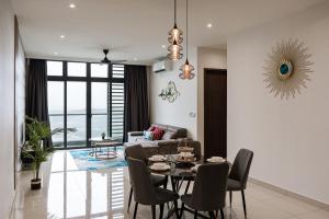 a living room with a table and chairs at Cozy couple apartment suite in Masai