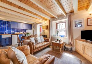 a living room with a couch and a table at Crown Mine Cottage in St. Just