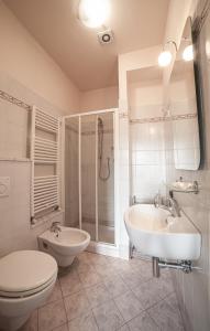 a bathroom with a toilet and a sink and a shower at Liberty GuestHouse in Lucca +19 photos
