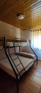 two bunk beds in a room with a wooden ceiling at Vivienda Turística Rural in Granada