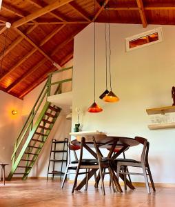 a dining room with a table and chairs at Blooming Botanic Houses in Estreito da Calheta