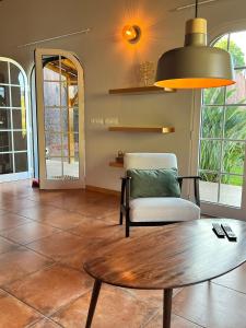 a living room with a table and a chair at Blooming Botanic Houses in Estreito da Calheta