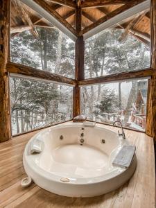 a large white tub in a room with windows at Cumbres Del Martial in Ushuaia +116 photos