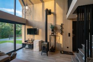 a living room with wood paneled walls and a television at Hytte Na Wyspie -,,Roztoczańskie Morze'' in Kulików +110 photos