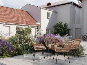 a group of chairs and a table in a garden at Güldenstubbe Residences in Kuressaare