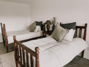 1 dormitorio con 2 camas con almohadas en Little Karoo, en Somerset East