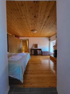Pokój z 2 łóżkami i drewnianym sufitem w obiekcie Παραδοσιακό σπίτι με θέα w mieście Tríkeri