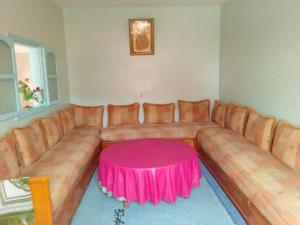 a living room with a couch with a pink table at aglou plage in Tiznit