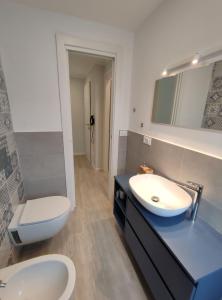 a bathroom with a sink and a toilet at Casa Charlotte in Rapallo