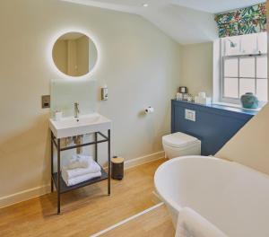 a bathroom with a sink and a toilet at Full Moon Inn Rudge in Frome