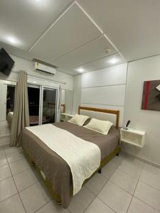 a bedroom with a large bed in a room at Cobertura Ilha da Madeira in Riviera de São Lourenço