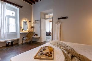 a bedroom with a tray of food on a bed at The Locals in Káto Potamiá