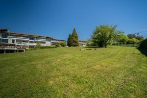 a large grassy field in front of a building at Centre Jean XXIII in Annecy