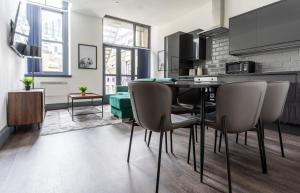 a kitchen and dining room with a table and chairs at Water Street by Ustay Aparthotels in Liverpool