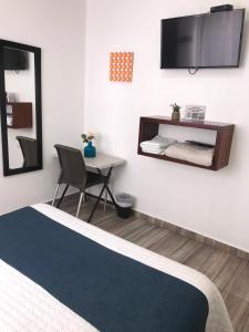 TV a/nebo společenská místnost v ubytování Hotel Maceo 55 - Colonial Inn