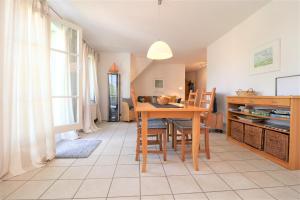 a kitchen and dining room with a table and chairs at Wohnpark Schmiedestraße App 03 in Wustrow