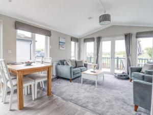 a living room with a table and chairs and a couch at 36 Bucklesham Park in Ipswich