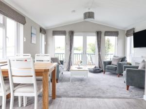 a living room with a table and chairs at 36 Bucklesham Park in Ipswich