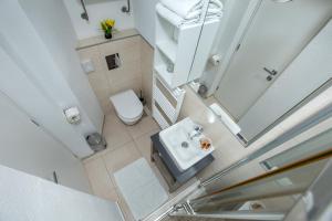 an overhead view of a bathroom with a toilet and sink at Pansion Kamenar in Primošten