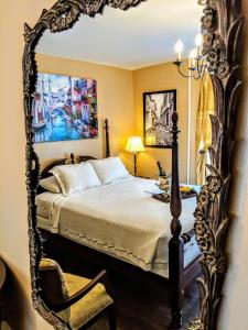 a bedroom with a bed in an ornate mirror at Chelsea Pub and Inn in Atlantic City
