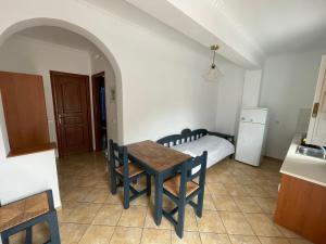 a kitchen and dining room with a table and a bed at Leonidas Apartments in Kamari +34 photos