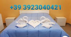 ein Bett mit zwei Schwänen in Handtüchern in der Unterkunft Casa Paradiso in Palmi