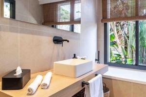 a bathroom with a sink and a window at Casa Bodhi Boutique Hotel & Spa in Marbella