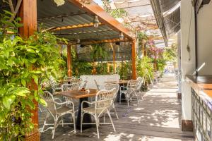 an outdoor patio with tables and chairs and plants at Parque Santiago III Official in Playa de las Americas