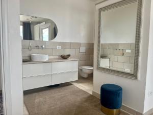 ein Bad mit einem Waschbecken und einem Spiegel in der Unterkunft Casa Eva in San Vito dei Normanni