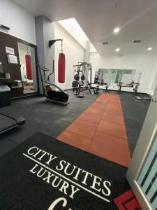 a gym with two boxing machines and a sign that says city surfaces luxury at CON GENERADOR Suite elegante piscina gym parqueo en el norte Gye in Guayaquil