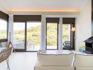 a living room with a couch and chairs and a balcony at Brisa Blanca Sa Riera Begur in Begur