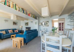 a living room with a blue couch and a table at The Kellan in Mousehole