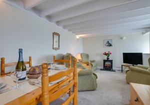 a living room with a table and a tv at Kelynack in Porthleven