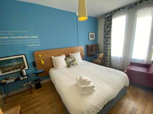 a bedroom with a large bed with a tray on it at Oscar H&ocirc;tel Le Havre Centre in Le Havre