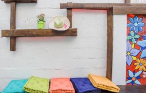 a shelf with colorful cushions on a wall at Rosalina Urbano in San Juan