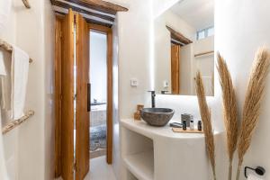 a bathroom with a sink and a mirror at The Locals in Káto Potamiá