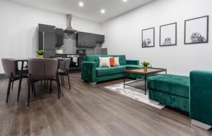 a living room with a green couch and a table at Water Street by Ustay Aparthotels in Liverpool