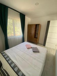 a bedroom with a bed and a window and a dresser at CanBey Apartları in Adrasan