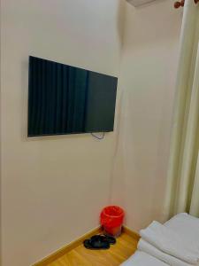 a flat screen tv on the wall of a bedroom at Upla Homestay in Vung Tau