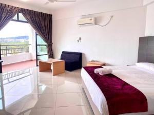 a hotel room with a bed and a balcony at Marina Heights Hotel Residences in Lumut