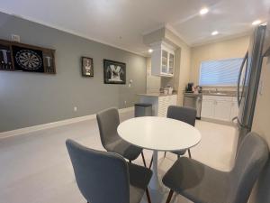 a dining room with a white table and chairs at Sports Themed 2bedApt w BEST location fully stocked 2 parking in Santa Clara