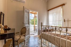 a bedroom with a bed and a desk and a window at The Locals in Káto Potamiá +27 photos